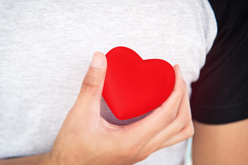 Man hand holding a red heart.Left