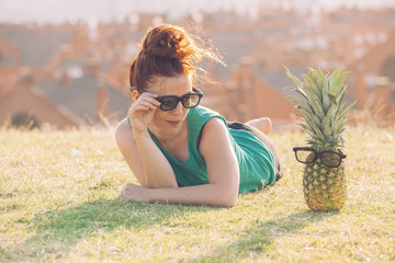 crazy woman looking funny to a pineapple with glasses