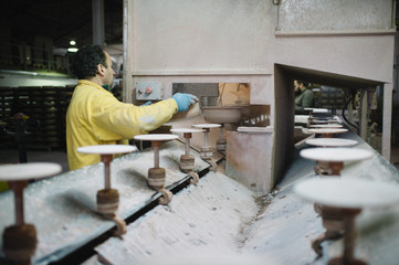 man that works in the factory of pottery