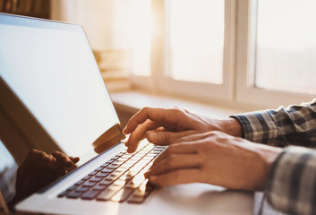 Businessman using laptop computer. Close up of male hands typing on laptop keyboard. Business working concept. Blogger, journalist writing new article