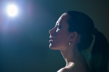 Beautiful glamorous woman on moon light background. Portrait
