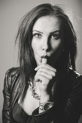 Beautiful glamorous woman in black leather jacket on light background, Portrait