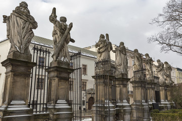 Fototapeta na wymiar Statues of Saints Peter and Paul Church fence. Krakow, Poland.