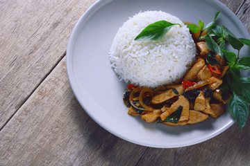 stir fried chicken with roasted chili paste and sweet basil leaf on jasmine rice, thai food.