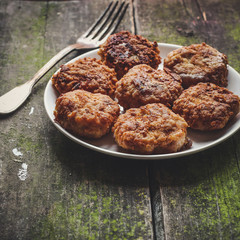 fried meatballs (burger) in a plate on the table