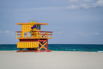 A colorful lifeguard station sits on Miami Beach, Florida on a sunny summer day