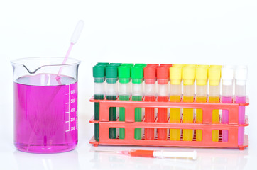 Set of chemical test tubes, syringe and beaker with permanganate