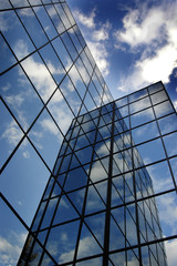 Fototapeta na wymiar Glass Building for Business Reflection of Blue Sky and Clouds