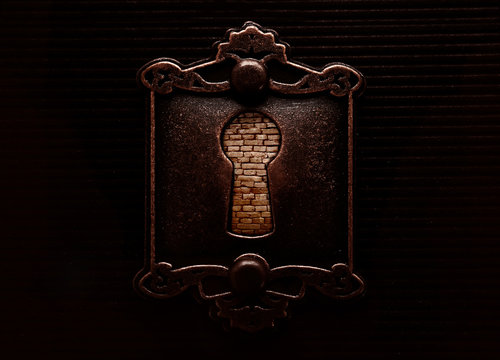 Antique keyhole with brickwall blocking it