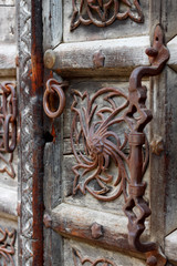 Old authentic wooden door with metal elements in Venice, Italy.