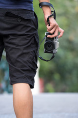 photographer holding camera, close-up. Back view, Selective focus