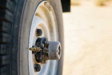Off-road tire with mounted tire deflator