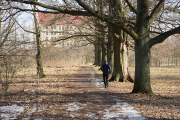 man rund in the forest in the early spring