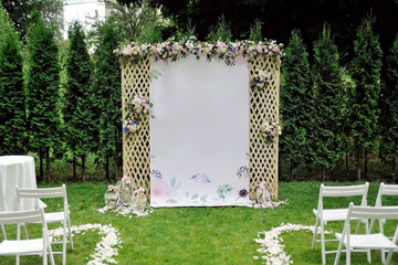 Beautiful wedding trellis decorated with flowers and congratulation on banner