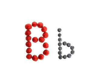 Alphabet from fresh fruit, raspberry and blackberry