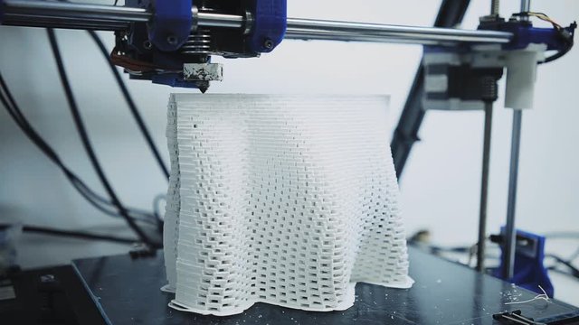 Industrial 3d printer at work, printing white architecture building mold with white pla filament, moves ahead and back, small business concept