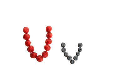 Alphabet from fresh fruit, raspberry and blackberry
