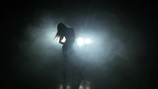 Beautiful girl dancing in the dark