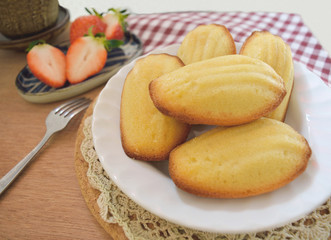 Homemade French Madeleine served with strawberries