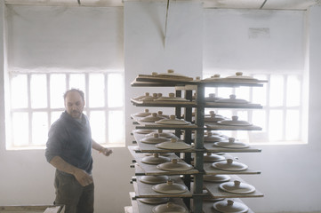 man that works in the factory of pottery