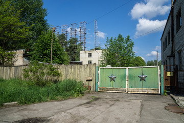 Green military gate with silver Soviet star at Chernobyl Exclusion Zone