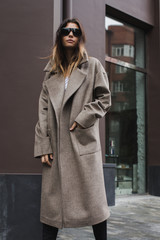 Confident woman in gray coat