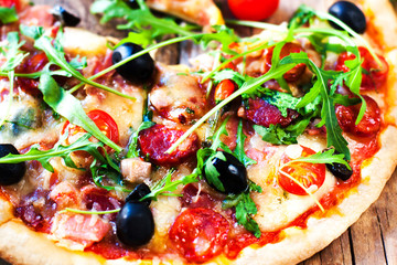 Fresh baked pepperoni pizza close up on wooden table, shallow depth of field,