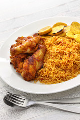 jollof rice with chicken and fried plantain, west african cuisine