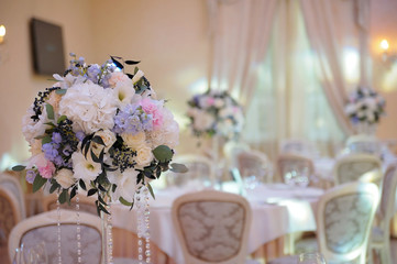 Wedding guest table decorated with bouquet and settings
