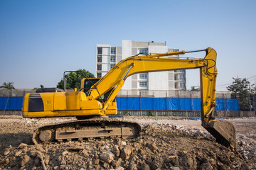 Obraz na płótnie Canvas yellow backhoe loader on construction site and work