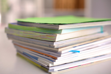 close up of stack of papers on white background