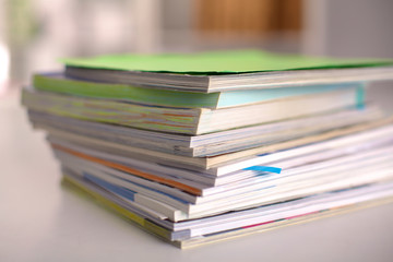 close up of stack of papers on white background