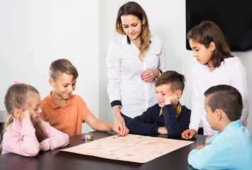 Fototapeta premium Children making move on pre-marked surface of board game