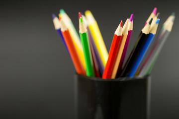 Obraz premium colored pencils on black background