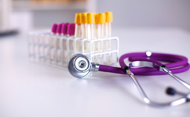 stethoscope near medical tubes on white background