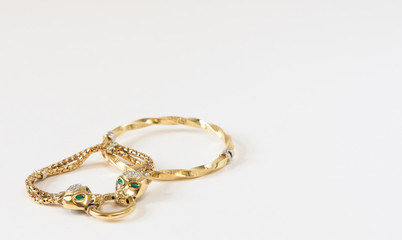 A few gold bracelets on white background. Woman's Jewelry.