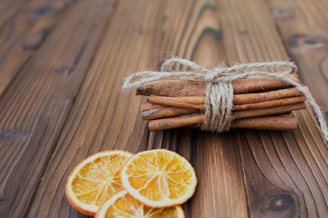 Cinnamon, dried oranges and anise on brown wooden table for cooking