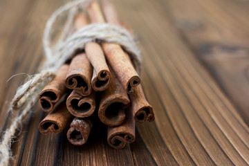 Cinnamon, dried oranges and anise on brown wooden table for cooking