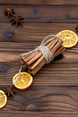 Cinnamon, dried oranges and anise on brown wooden table for cooking