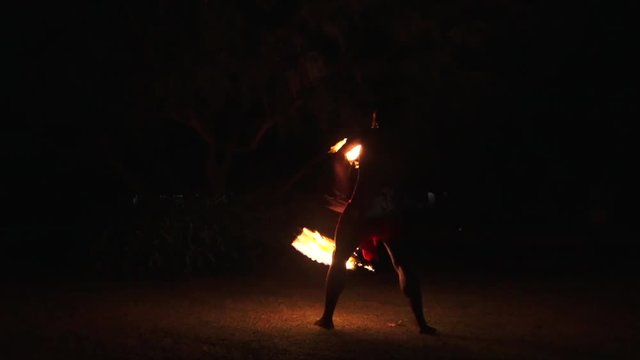 Indigenous Fijian man during a fire dance at nigh in Fiji