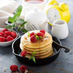 Stack of fluffy buttermilk pancakes with raspberry and coconut