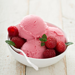 Raspberry ice cream in white bowl