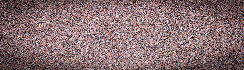 Texture of small, multi-colored crumbs of basalt, abstract background