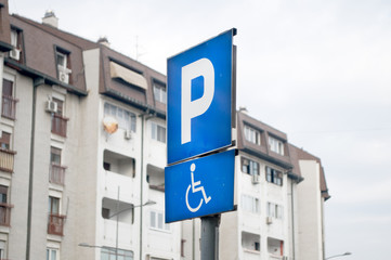 Traffic sign indicating a parking place and a place for people with disabilities with cars, Novi Sad, Serbia