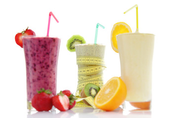Healthy Smoothies with Measuring Tape and Strawberries, Kiwis and Oranges, for a good slim start in your day