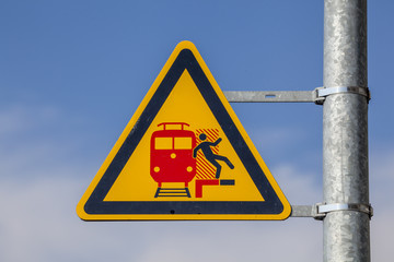Warnschild an einem Bahnsteig