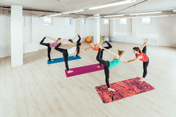 Fototapeta premium women are practicing yoga exercises in the studio. pair yoga concept.