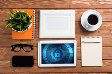 Web security and technology concept with tablet pc on wooden table