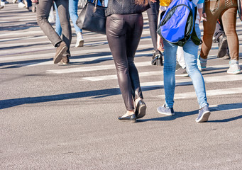 pedestrians walking on a pedestrian crossing
