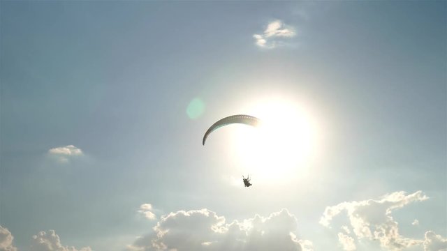 Paraglider on a background of the sun